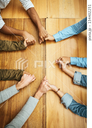 Hands holding, support and people planning together for prayer circle, love and care in a team building table. Above, community and group teamwork by employees with hope, collaboration and help Hands holding, support and people planning together for prayer circle, love and care in a team building table. Above, community and group teamwork by employees with hope, collaboration and help 134402251