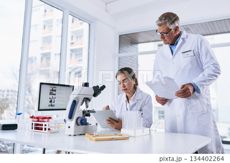 Scientist, tablet and teamwork in forensic science looking at experiment results or collaboration at laboratory. Woman and man in medical research working on technology for scientific research in lab 134402264