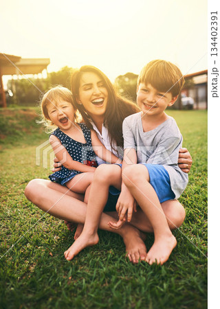 Mother, happy kids or hug playing on grass for fun bonding in summer outside a house in nature. Funny mom hugging playful children on garden playground outdoors with happiness of family together Mother, happy kids or hug playing on grass for fun bonding in summer outside a house in nature. Funny mom hugging playful children on garden playground outdoors with happiness of family together 134402391