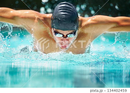 Health, sports and training with man in swimming pool for competition, workout and energy. Strong, water splash and cardio with male swimmer and practice for athlete, championship and race at gala 134402459