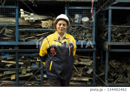 Portrait of technician women worker stand, looking camera happy smiling in garage scrap yard car workshop warehouse. 134402462