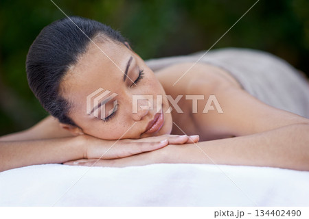 Sleep, massage and a woman on a spa bed for stress relief, luxury relaxation and wellbeing in nature. Relax, calm and a young lady sleeping after a skin treatment, pampering and wellness in a garden 134402490