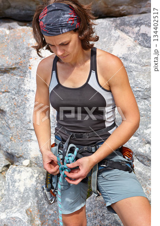 Woman climbing mountains with safety rope, gear and workout for adventure, fitness challenge and fearless athlete. Sports, knot and equipment for female climber, hiker and exercise at rocks in nature Woman climbing mountains with safety rope, gear and workout for adventure, fitness challenge and fearless athlete. Sports, knot and equipment for female climber, hiker and exercise at rocks in nature 134402517
