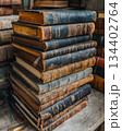 Stacked antique books reveal stories from the past in a cozy library setting. Generative AI 134402764