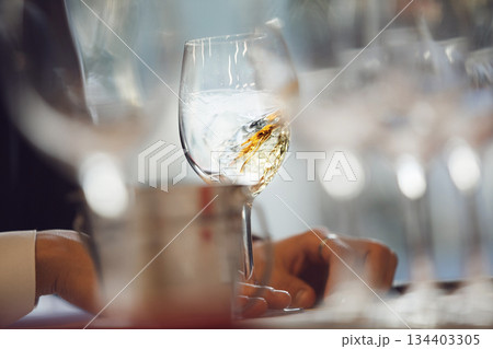 Close-up Swirling White Wine by Sommelier Close-up Swirling White Wine by Sommelier 134403305