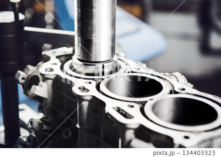 Car engine cylinder head on CNC machine during service boring piston for increase power. Car engine cylinder head on CNC machine during service boring piston for increase power. 134403323