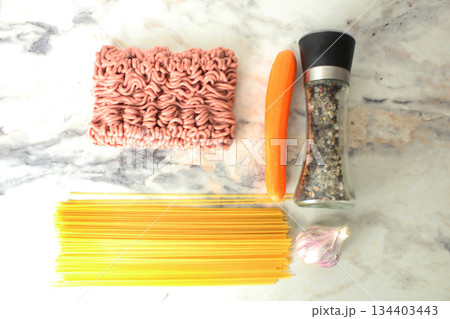 minced meat spaghetti carrots garlic spices pepper top view. Layout of products for cooking pasta. 134403443