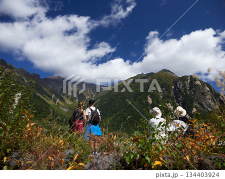 観光名所上高地の梓川沿岸で休憩する観光客の姿と穂高連峰の風景 観光名所上高地の梓川沿岸で休憩する観光客の姿と穂高連峰の風景 134403924