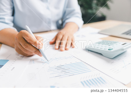 Business professional analyzing financial charts, performance graphs paper, illustrating data review, corporate planning accounting workflow strategic decision-making financial performance evaluation Business professional analyzing financial charts, performance graphs paper, illustrating data review, corporate planning accounting workflow strategic decision-making financial performance evaluation 134404555