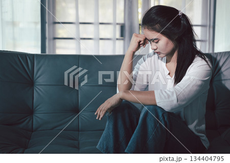 Sorrowful woman sat alone, overwhelmed by emotion, her sad and unhappy expression revealing deep despair, stress and distress left feeling depressed. sorrowful sad, despair alone, depressed stress Sorrowful woman sat alone, overwhelmed by emotion, her sad and unhappy expression revealing deep despair, stress and distress left feeling depressed. sorrowful sad, despair alone, depressed stress 134404795