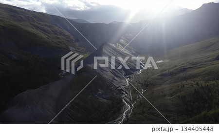 Sunlight illuminating mountain valley with river. Media Sunlight illuminating mountain valley with river. Media 134405448