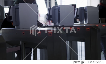 Passengers passing through automatic turnstile gates. Media Passengers passing through automatic turnstile gates. Media 134405450
