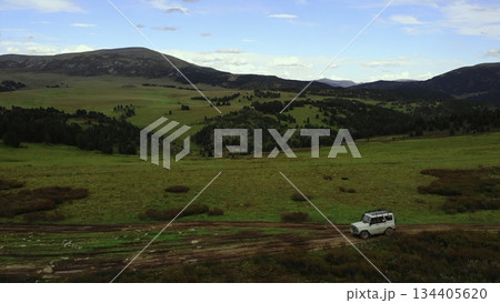 Off road vehicle driving on a mountain dirt road. Media Off road vehicle driving on a mountain dirt road. Media 134405620
