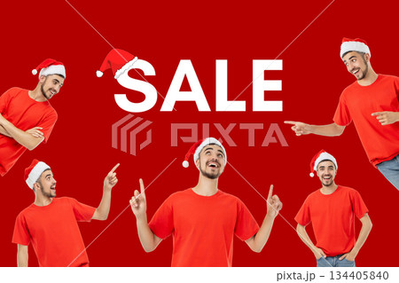 Young man wearing a red shirt and Santa hat points to sale text 134405840