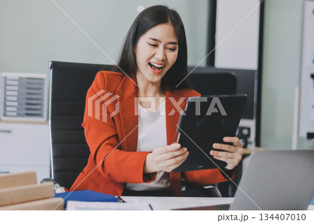 Beautiful young woman working using touchpad tablet 134407010