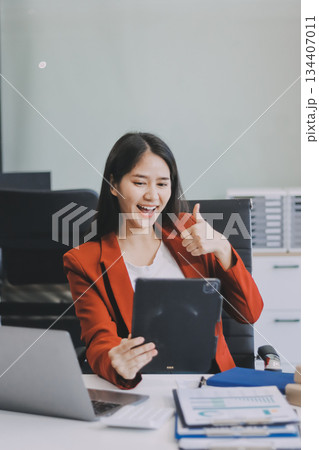 Beautiful young woman working using touchpad tablet 134407011