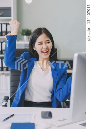 Asian business woman working on a laptop in a professional office Asian business woman working on a laptop in a professional office 134407018