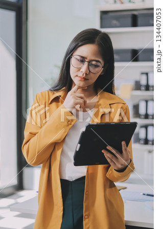Business woman using calculator for do math finance on wooden desk in office and business working background, tax, accounting, statistics and analytic research concept. Business woman using calculator for do math finance on wooden desk in office and business working background, tax, accounting, statistics and analytic research concept. 134407053
