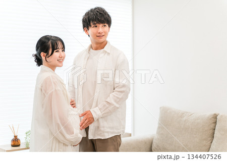 マイホームのリビングにいる夫婦,妊婦（マタニティ） 134407526
