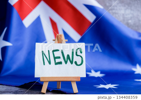Flag-themed board with NEWS text for media headlines. Patriotic mockup with text NEWS Vibrant Australian flag background trending for current affairs content. Concept of national reporting 134408359