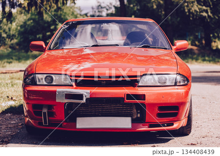 A bright red sports car. A stylish retro feel and a strong emphasis on the car's design. Car racing, street racing. A bright red sports car. A stylish retro feel and a strong emphasis on the car's design. Car racing, street racing. 134408439