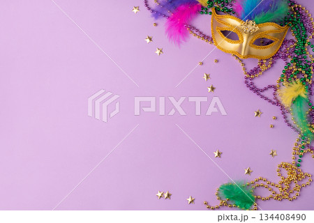 Mardi Gras and fat Tuesday background. Festive decorations on a lilac background Mardi Gras and fat Tuesday background. Festive decorations on a lilac background 134408490