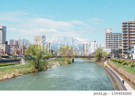 Beautiful Iwate mountain and Kitakami river with flowers blooming in Spring season, cityscape against blue sky in Morioka city, Iwate prefecture, Japan. Iwate, Japan, 24 April 2025 134408860