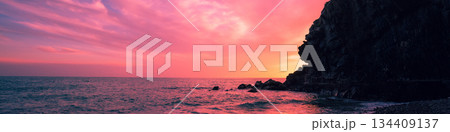 Sunset over rocky sea coast 134409137