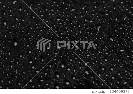 shiny surface covered with clear water droplets of different sizes, black glass covered with a large number of water droplets 134409573