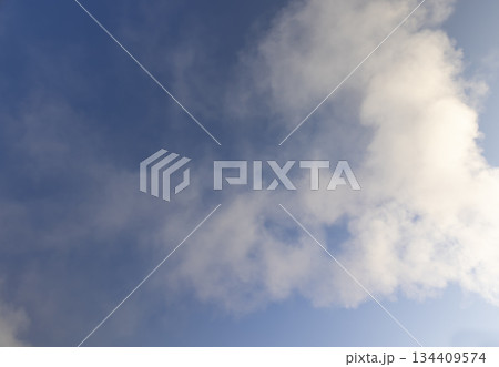 smoke coming from a pipe against a blue sky background, white steam coming from a pipe during heating of a large industrial premises in cold weather 134409574