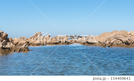 Wide view of rocky coastline and open blue sea under clear sky. Natural seaside panorama, travel background and summer vacation concept, Sardinian, La Maddalena, Italy 134409641