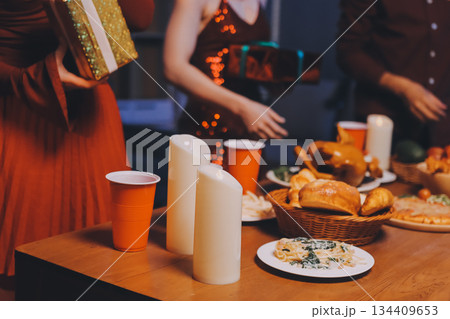 Festive Office Christmas Party with Delicious Food. A beautifully decorated office space with Christmas trees and festive lights, set up for a holiday party. 134409653