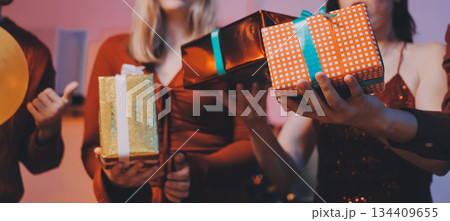 Festive Office Christmas Party with Delicious Food. A beautifully decorated office space with Christmas trees and festive lights, set up for a holiday party. 134409655