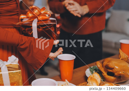 Festive Office Christmas Party with Delicious Food. A beautifully decorated office space with Christmas trees and festive lights, set up for a holiday party. 134409660