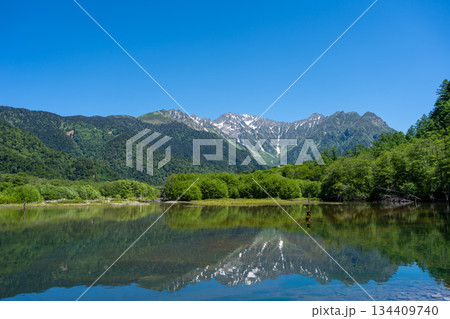 Mount Hotaka reflection on Kamikochi hiking trail in Japan 134409740