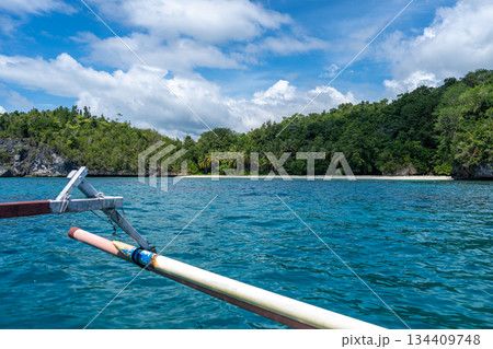 Boat approaching island, Togian Islands, Sulawesi, Indonesia Boat approaching island, Togian Islands, Sulawesi, Indonesia 134409748