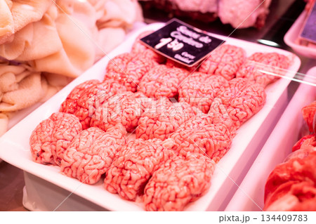 Raw sheep brains on counter of butcher shop Raw sheep brains on counter of butcher shop 134409783