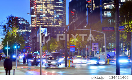 Warsaw, Poland. 4 November 2025. City life after dark. Traffic with cars passing on the street in center city in the night. Lights street and buildings towering around them. 134411403