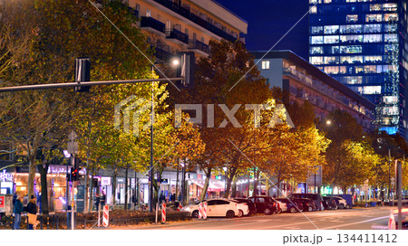 Warsaw, Poland. 4 November 2025. City life after dark. Traffic with cars passing on the street in center city in the night. Lights street and buildings towering around them. Warsaw, Poland. 4 November 2025. City life after dark. Traffic with cars passing on the street in center city in the night. Lights street and buildings towering around them. 134411412