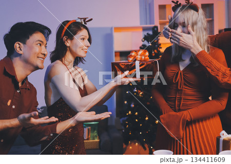 Festive Office Christmas Party with Delicious Food. A beautifully decorated office space with Christmas trees and festive lights, set up for a holiday party. 134411609