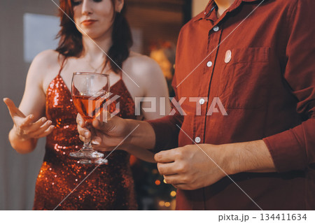 Festive Office Christmas Party with Delicious Food. A beautifully decorated office space with Christmas trees and festive lights, set up for a holiday party. 134411634