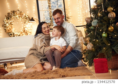 On the floor, sitting. Happy family celebrating new year together at home 134412570
