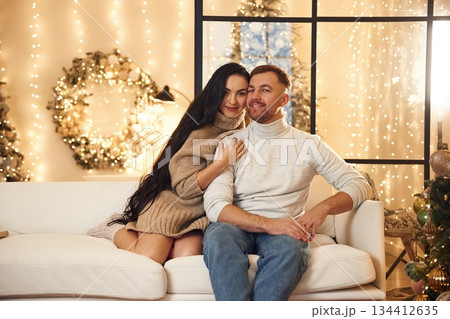 Couple is celebrating new year indoors together Couple is celebrating new year indoors together 134412635