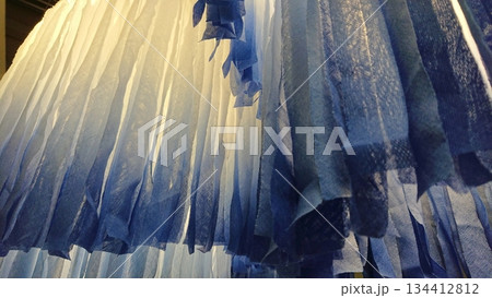 Abstract blue fabric texture with soft light folds 134412812