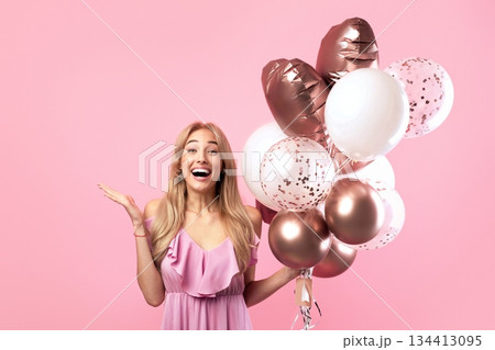 Portrait of excited millennial lady with bunch of balloons for birthday or Woman's Day, celerating holiday on pink studio background. Romantic blonde in pretty dress having party Portrait of excited millennial lady with bunch of balloons for birthday or Woman's Day, celerating holiday on pink studio background. Romantic blonde in pretty dress having party 134413095