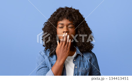 Tired african american young curly woman yawning on yellow studio background, sleepy inattentive deprived black female feeling somnolent lazy bored gaping suffering from lack of sleep, closeup Tired african american young curly woman yawning on yellow studio background, sleepy inattentive deprived black female feeling somnolent lazy bored gaping suffering from lack of sleep, closeup 134413451