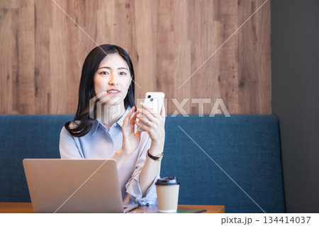 カフェで仕事をする女性 134414037