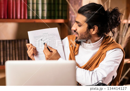 E-Teaching. Arab Teacher Guy At Laptop Computer Having Online Class Webinar With Student Via Video Call Sitting At Home. Online Tutoring, Distance Education Concept. Selective Focus 134414127