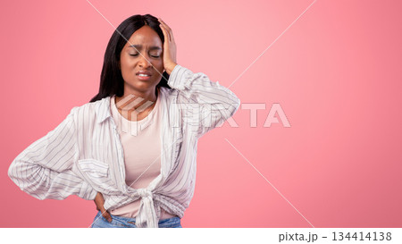 Overworked black woman suffering from headache on pink studio background. Stressed African American lady having migraine or hypertension, feeling exhausted, failing to solve problem 134414138