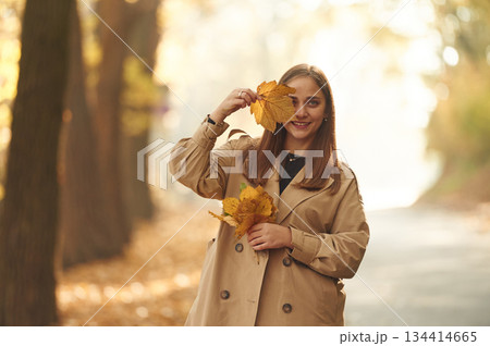 Happy woman is in the autumn forest Happy woman is in the autumn forest 134414665